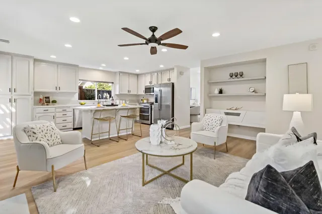 a living room with furniture a window and a chandelier