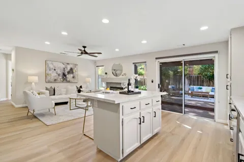 a view of living room with kitchen island furniture and fireplace