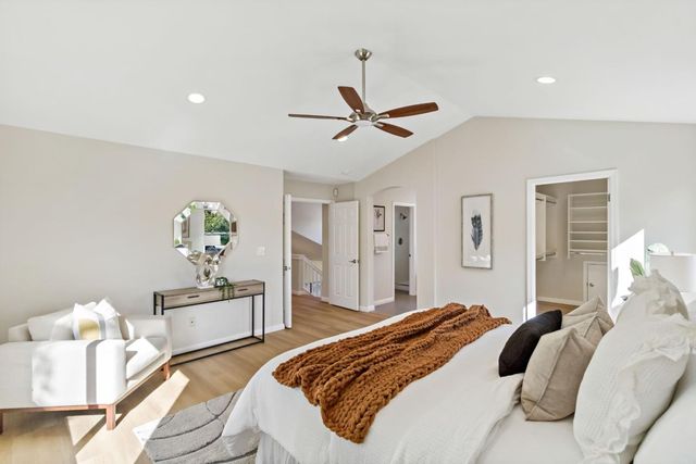 a spacious bathroom with a toilet a sink and a mirror