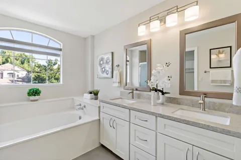 a bathroom with a bathtub a sink and a window