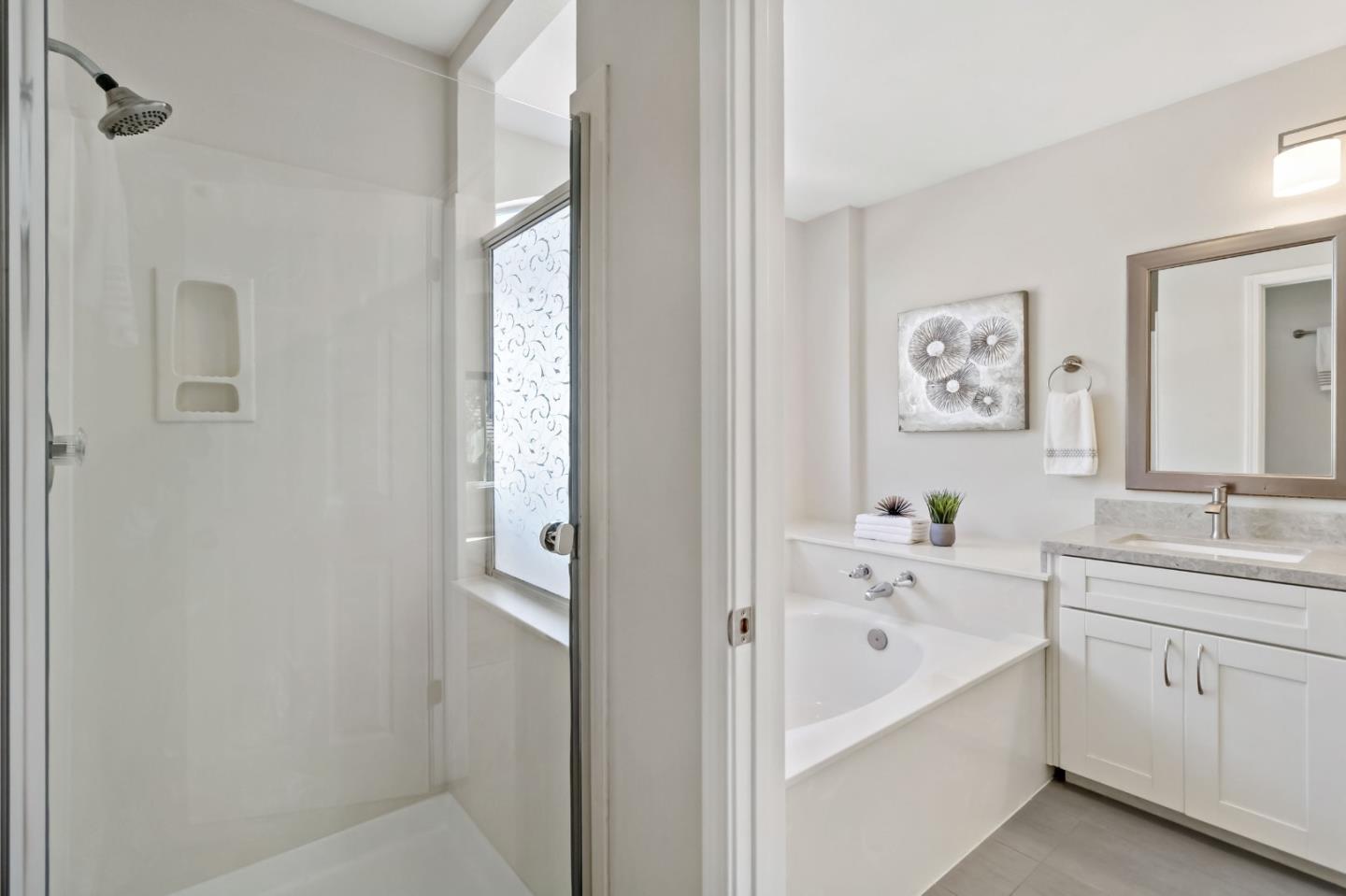 4593 Fallstone Court San Jose, CA 95124 - Photo 31 of 59 a bathroom with a bathtub a sink and a window