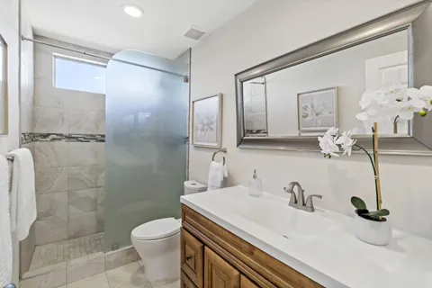 a bathroom with a sink toilet and shower