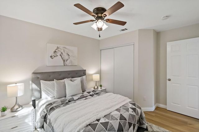 a bedroom with a bed and a chandelier