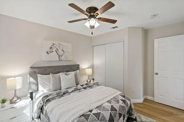 a bedroom with a bed and a chandelier