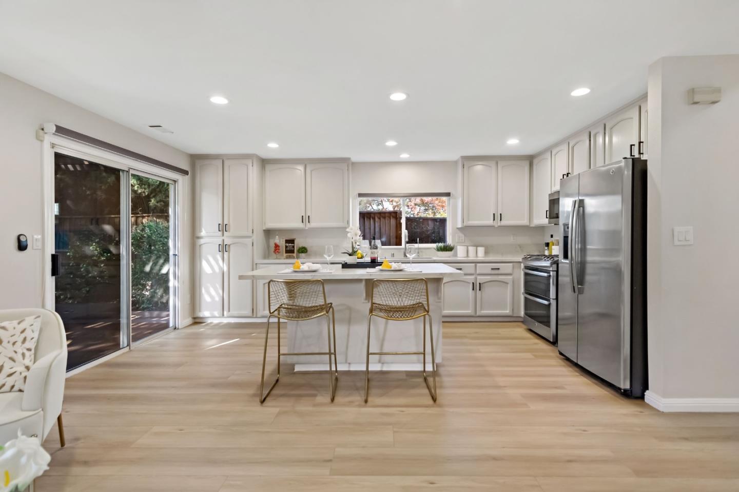 4593 Fallstone Court San Jose, CA 95124 - Photo 4 of 59 a kitchen with a sink a counter top stainless steel appliances and cabinets