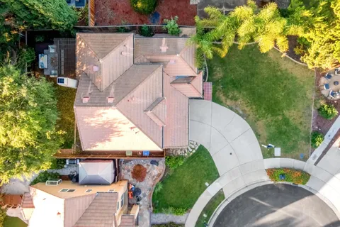 an aerial view of a house with garden space and street view