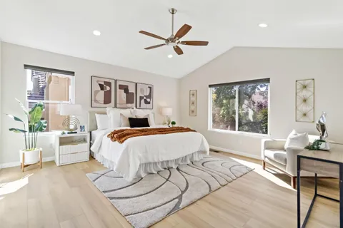 a bed sitting in a bedroom and window