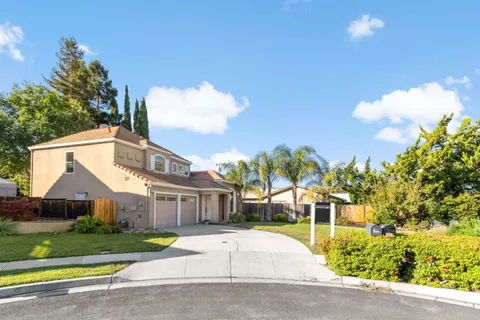 a front view of a house with a yard and a garage