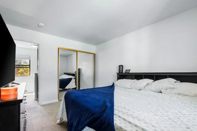 a bedroom with a bed and a flat screen tv