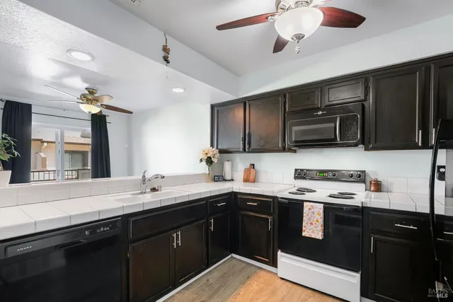 a kitchen with a sink stainless steel appliances and cabinets