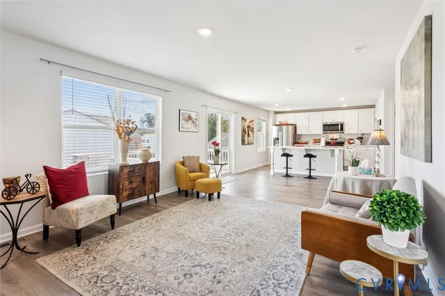 a living room with furniture and wooden floor