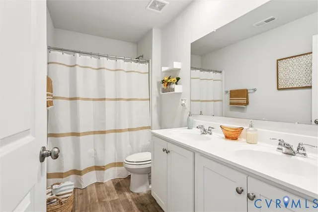 a bathroom with a sink a mirror and shower