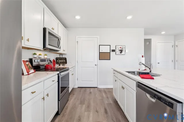 a kitchen with granite countertop lots of counter top space and wooden floor