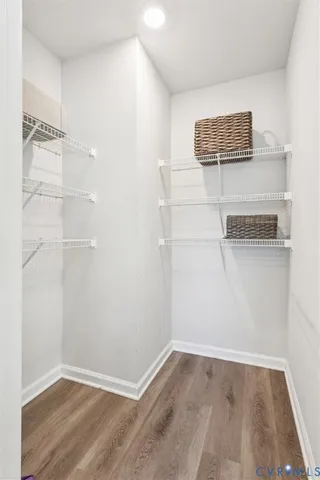 a view of a room with wooden floor
