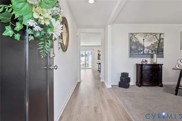 a view of a hallway with paintings on the wall