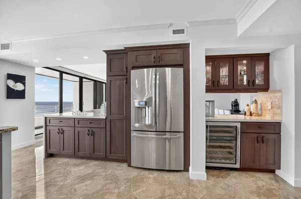 a kitchen with granite countertop white cabinets and stainless steel appliances