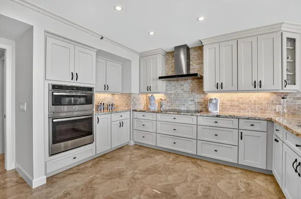a large bedroom with a bed and wooden floor