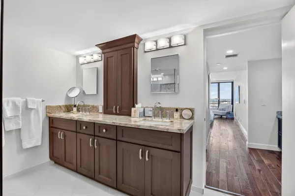 a bedroom with two beds and wooden floor