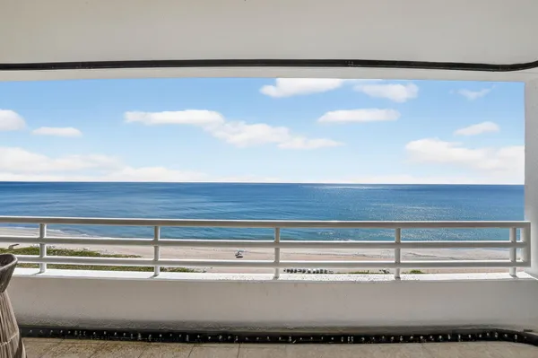a dining room with furniture and a floor to ceiling window