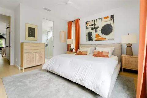 a bedroom with a bed and cabinets