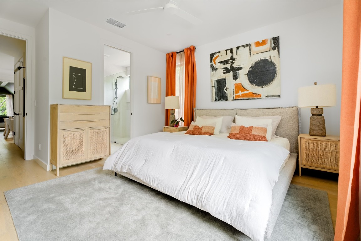 4911 Duval Street Austin, TX 78751 - Photo 19 of 40 a bedroom with a bed and cabinets