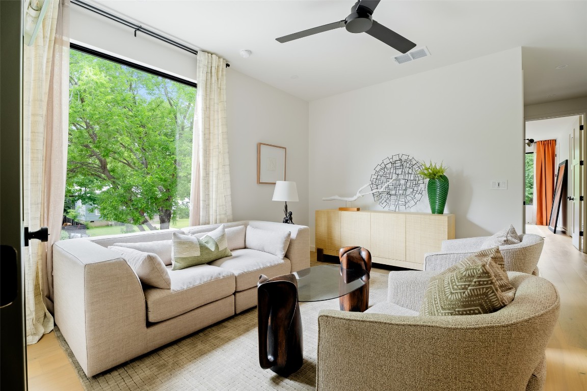 4911 Duval Street Austin, TX 78751 - Photo 24 of 40 Living room with a ceiling fan, light wood-style flooring, and visible vents