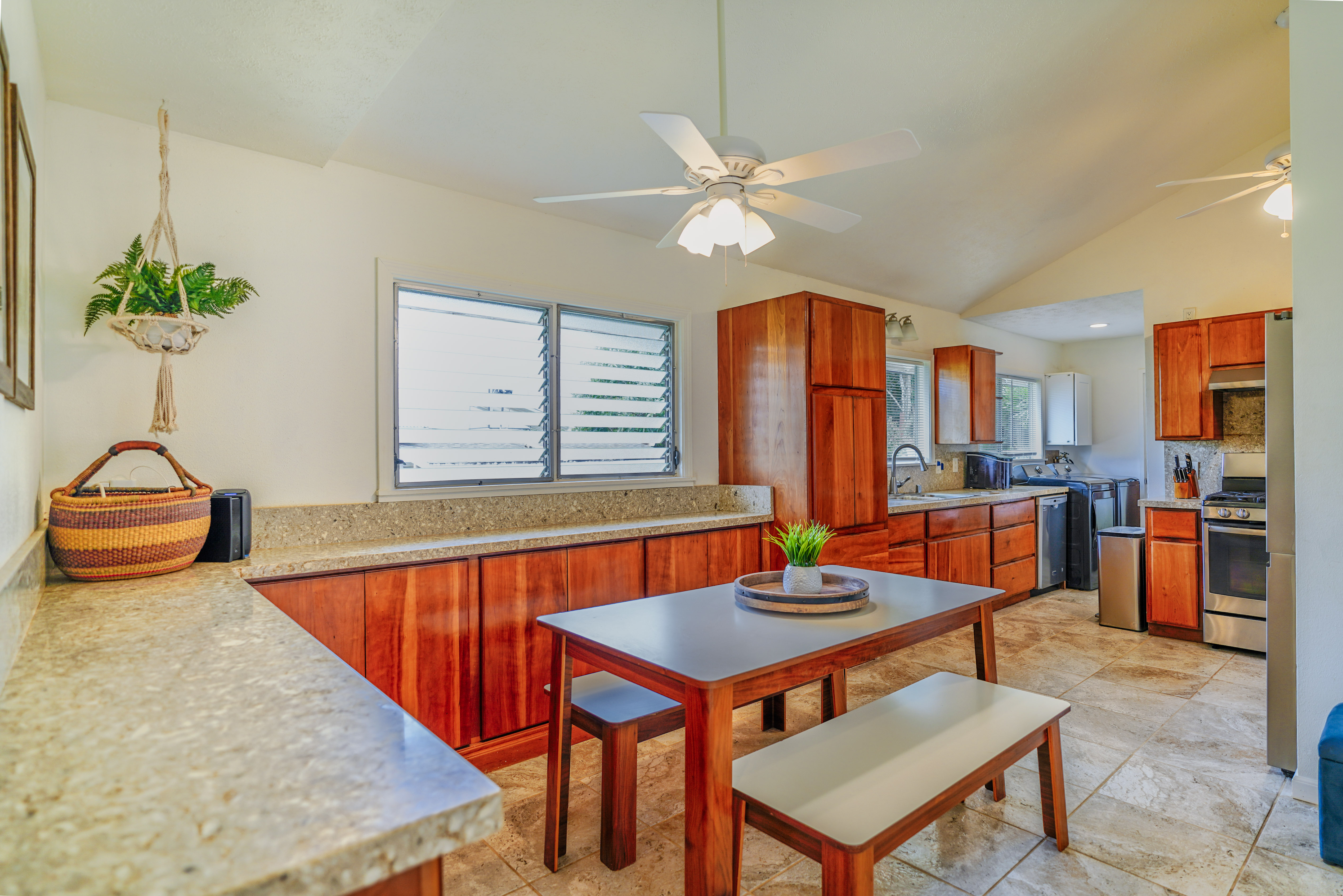 316 A Makani Road, Unit A Kapaa, HI 96746 - Photo 9 of 29 a living room with furniture a chandelier and a dining table