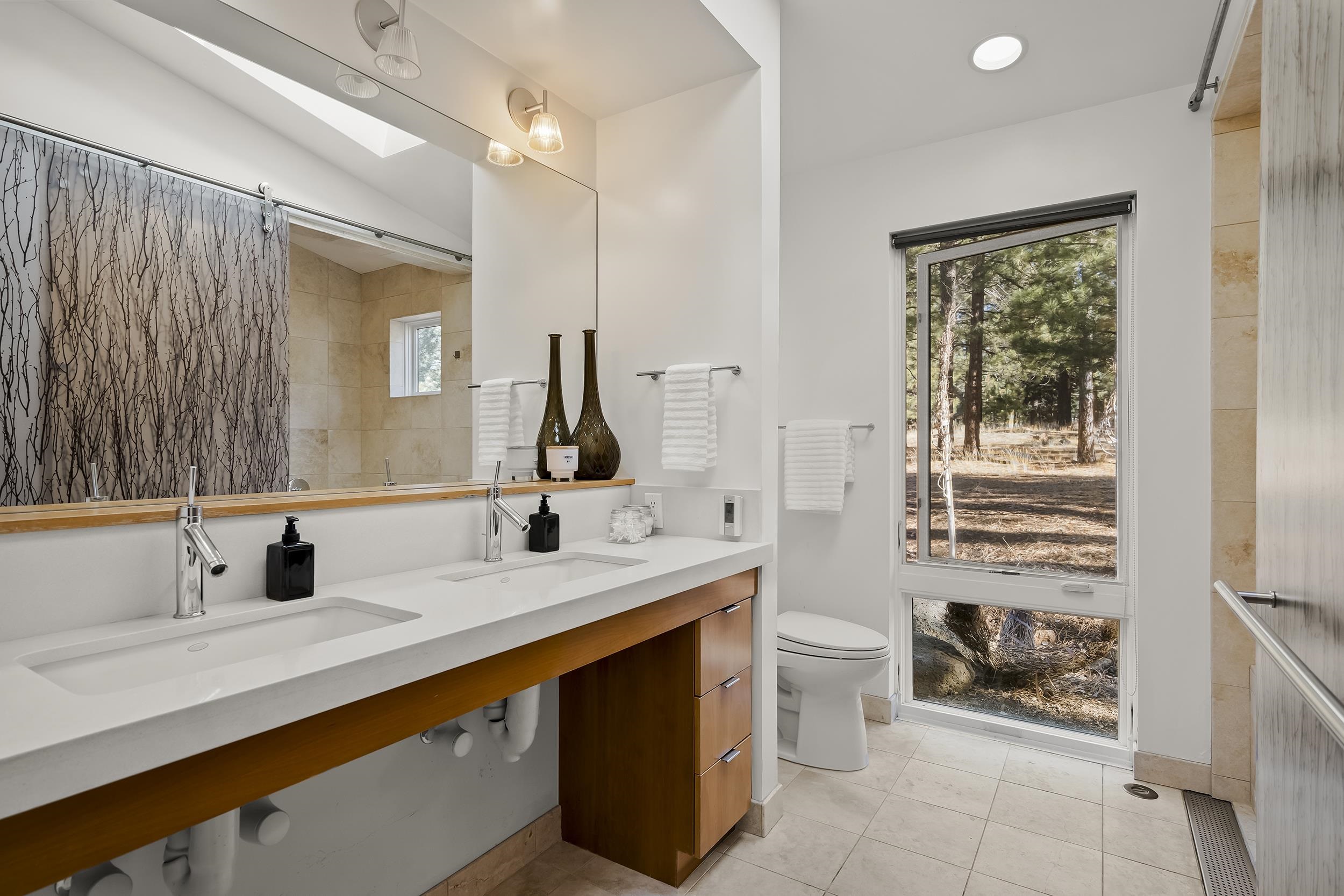 11906 Stallion Way Truckee, CA 96161 - Photo 15 of 20 a bathroom with a double vanity sink toilet and a shower