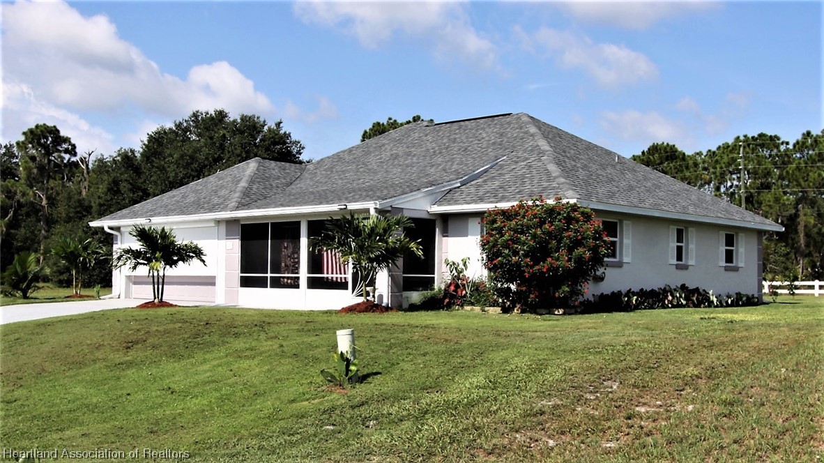 20 Quail Roost Road Lake Placid, FL 33852 - Photo 2 of 28 a view of a house with a yard and sitting area