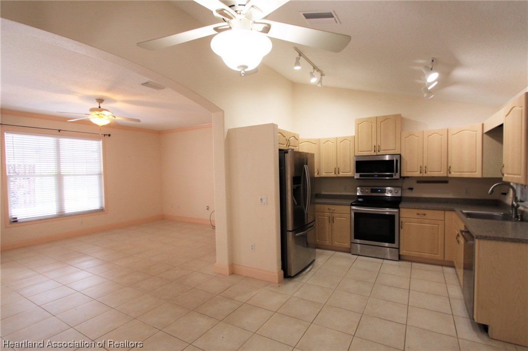 20 Quail Roost Road Lake Placid, FL 33852 - Photo 22 of 28 a kitchen with stainless steel appliances granite countertop a refrigerator and a sink