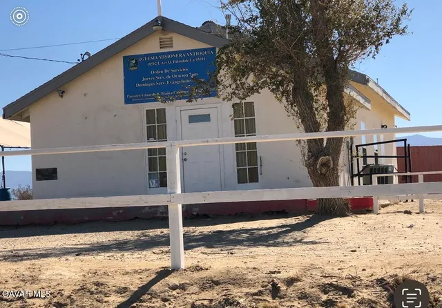a view of a house with snow on the background