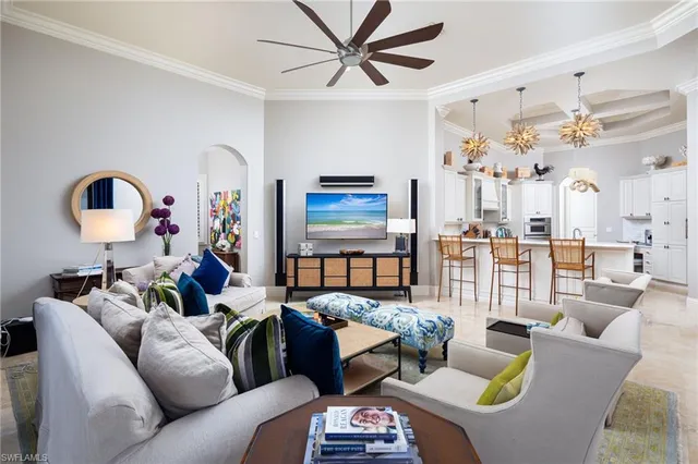 a living room with furniture a large window and a flat screen tv
