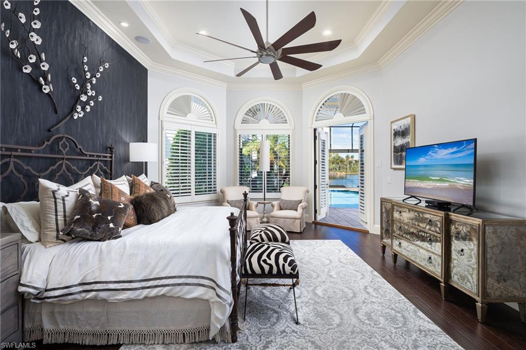 4610 Via Cappello Estero, FL 34134 - Photo 21 of 50 a bedroom with furniture and a flat screen tv