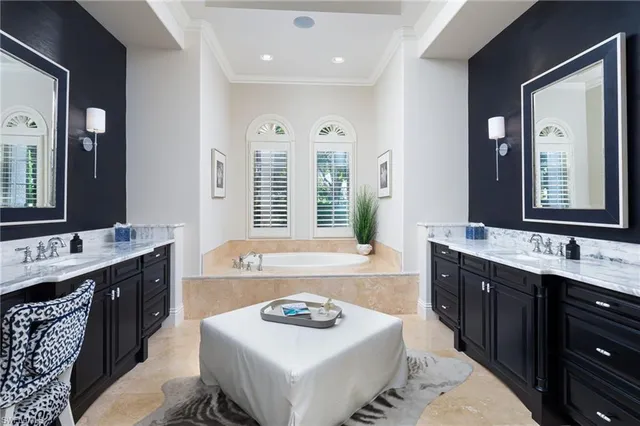 a bathroom with a granite countertop sink a large mirror and a bathtub