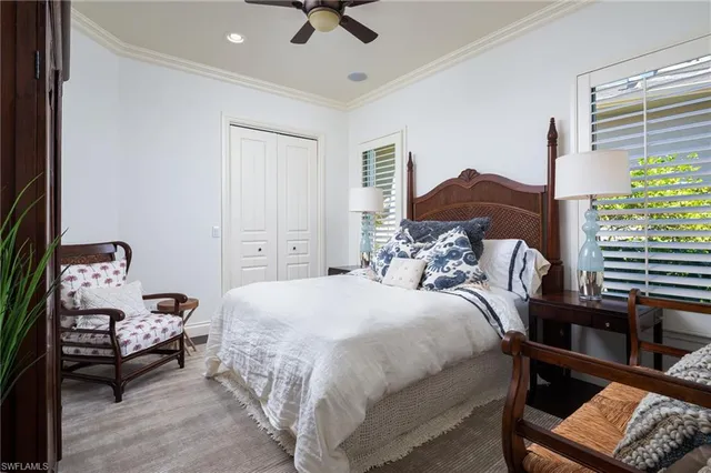 a bedroom with a bed a couch and a window