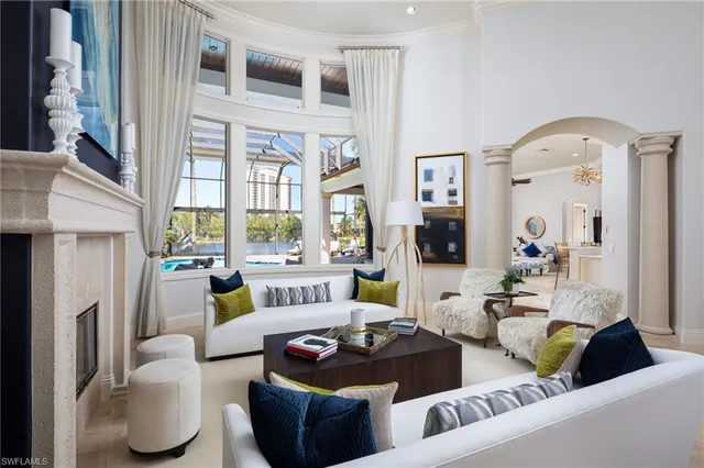 a living room with furniture and a floor to ceiling window