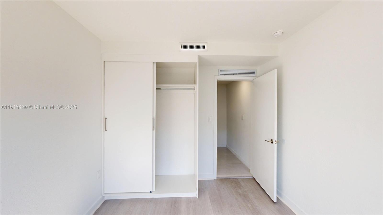 14546 Southwest 260th Street, Unit 14546 Homestead, FL 33032 - Photo 15 of 31 a view of a hallway with wooden floor