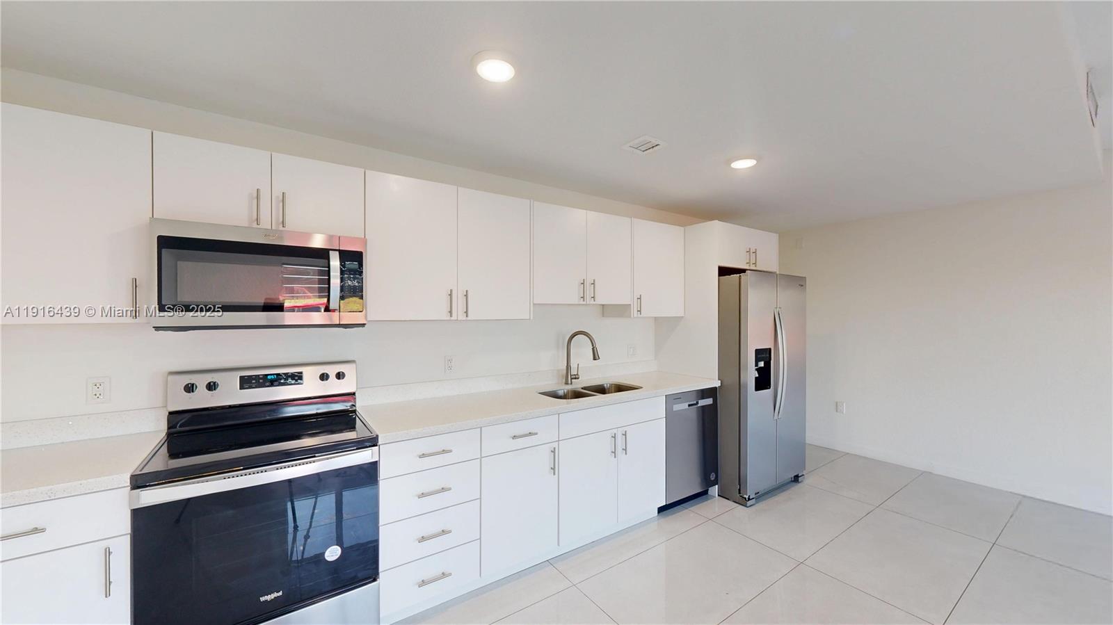 14546 Southwest 260th Street, Unit 14546 Homestead, FL 33032 - Photo 2 of 31 a kitchen with cabinets stainless steel appliances and sink