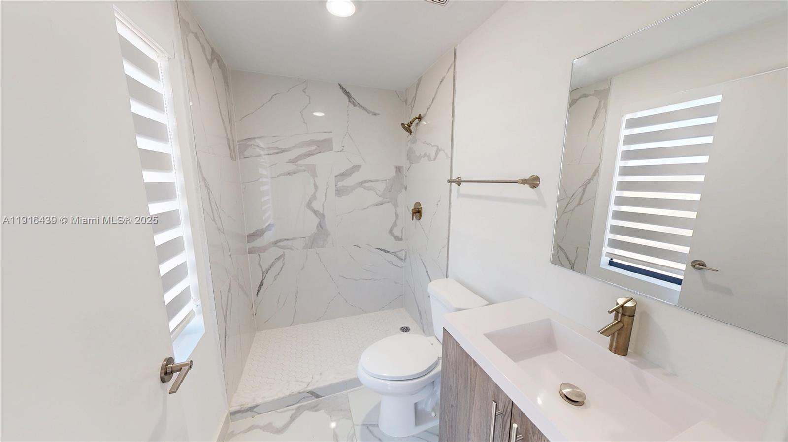14546 Southwest 260th Street, Unit 14546 Homestead, FL 33032 - Photo 21 of 31 a bathroom with a sink toilet and shower