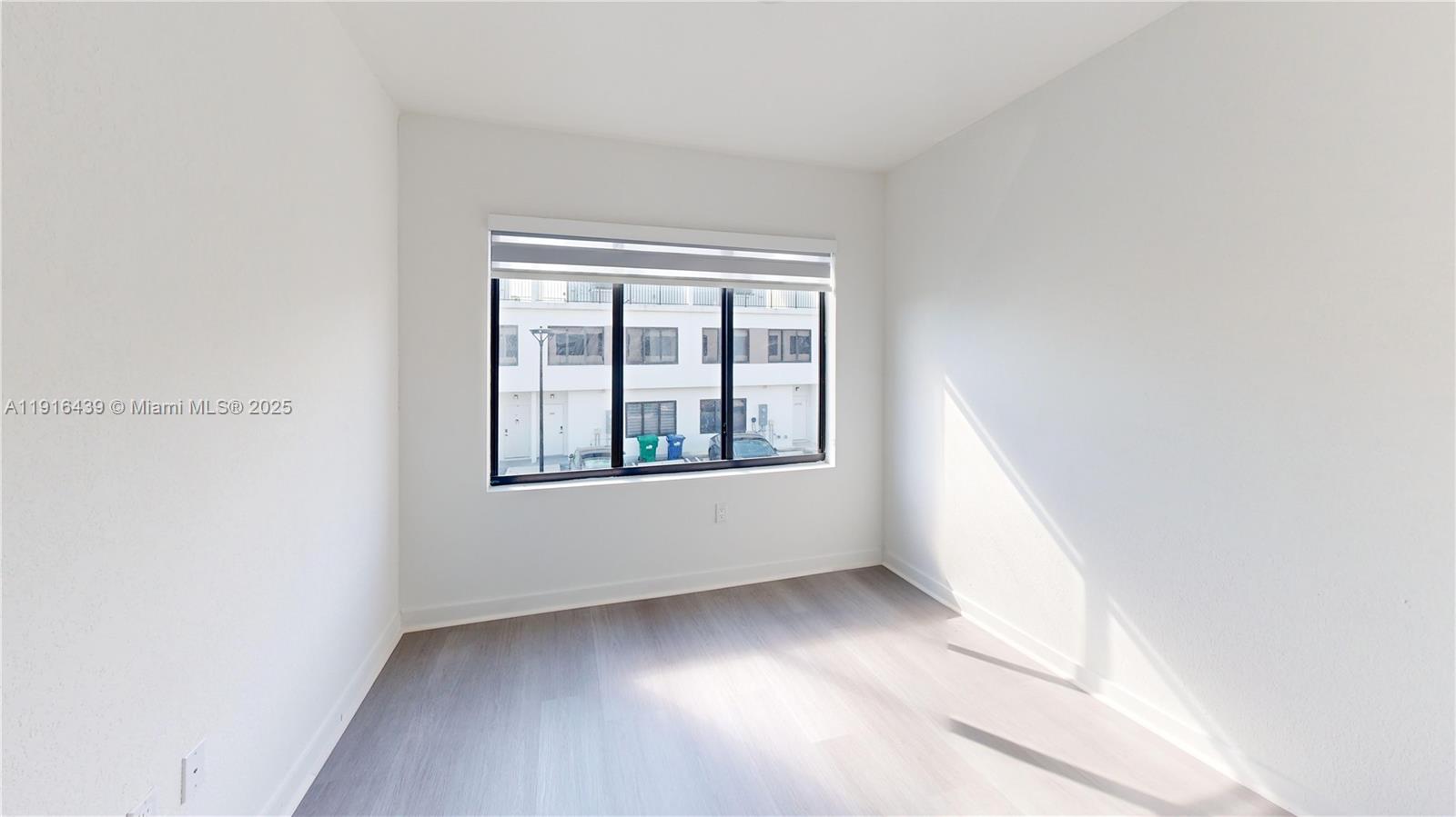 14546 Southwest 260th Street, Unit 14546 Homestead, FL 33032 - Photo 23 of 31 a view of an empty room with a window