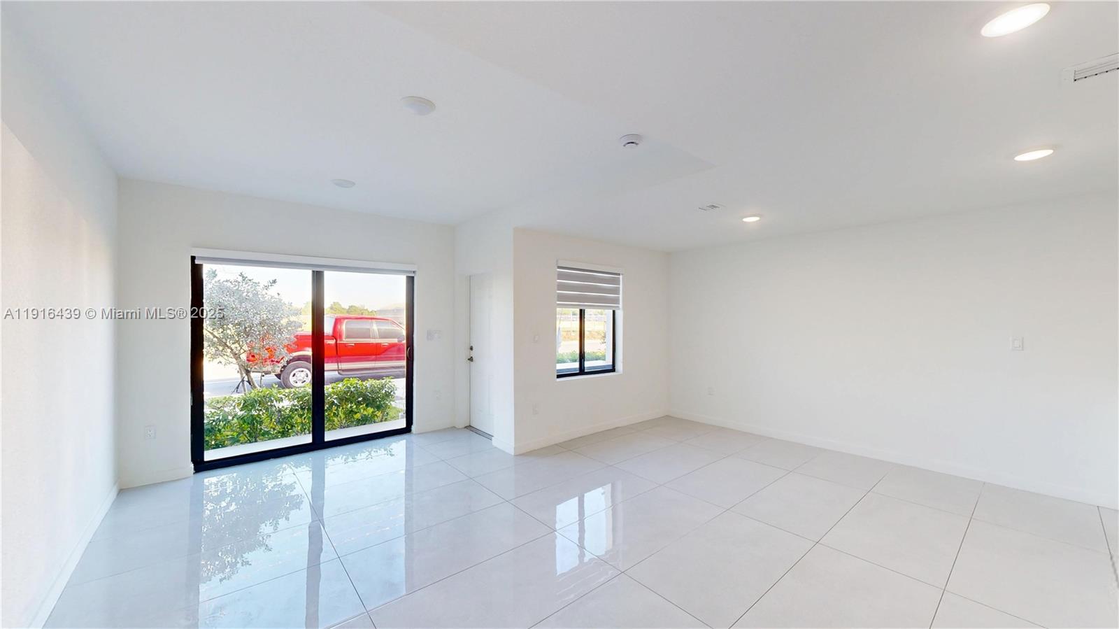 14546 Southwest 260th Street, Unit 14546 Homestead, FL 33032 - Photo 7 of 31 an empty room with windows