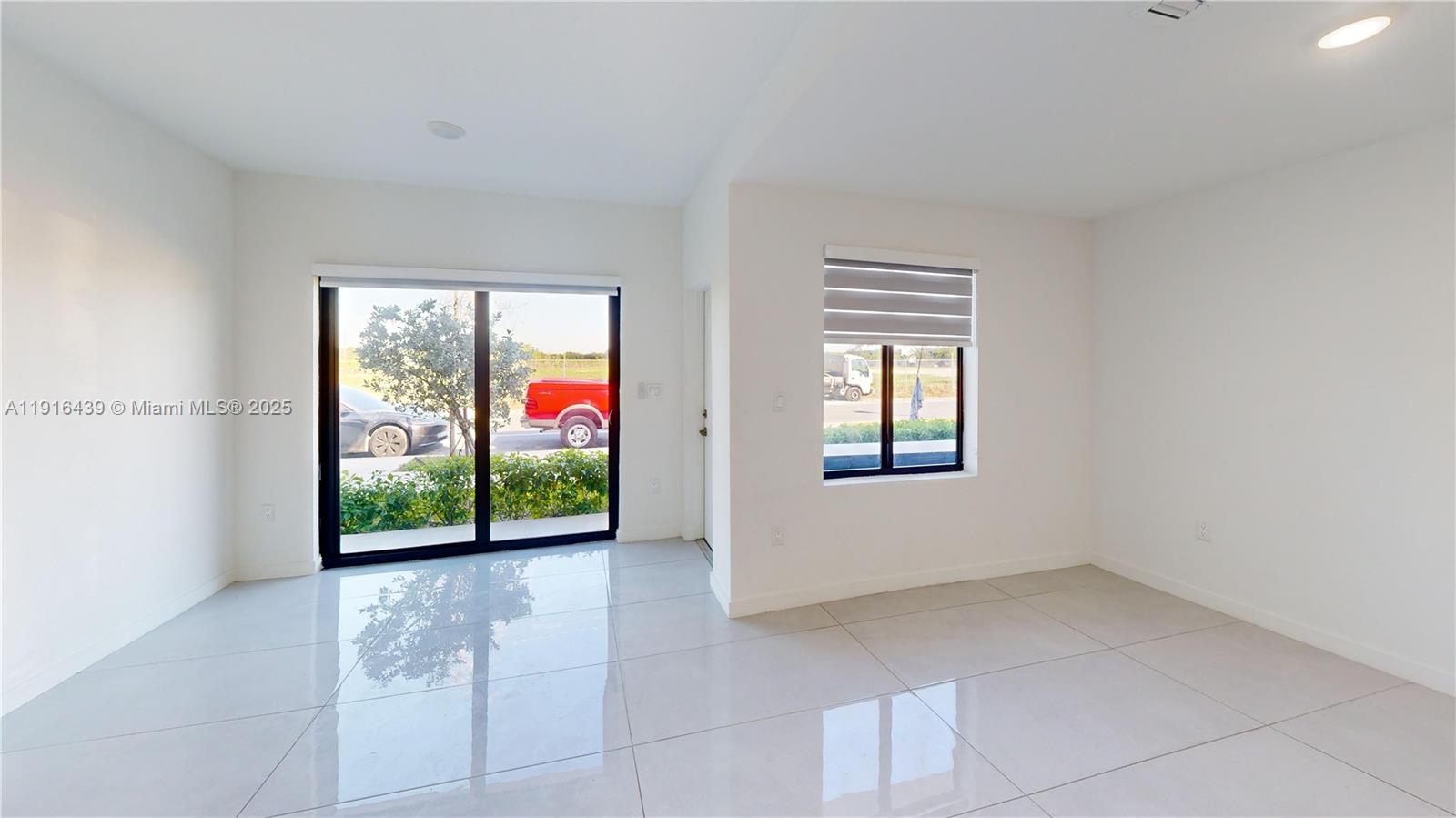 14546 Southwest 260th Street, Unit 14546 Homestead, FL 33032 - Photo 8 of 31 a view of an empty room with window