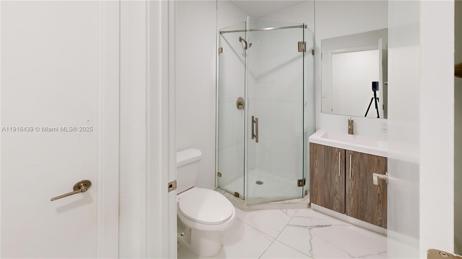 14546 Southwest 260th Street, Unit 14546 Homestead, FL 33032 - Photo 9 of 31 a bathroom with a sink and a mirror