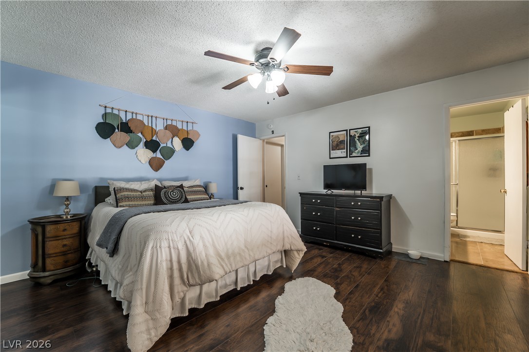 1324 Appaloosa Road Boulder City, NV 89005 - Photo 20 of 42 Hardwood floors and a ceiling fan create a comfortable atmosphere in this well-appointed bedroom.