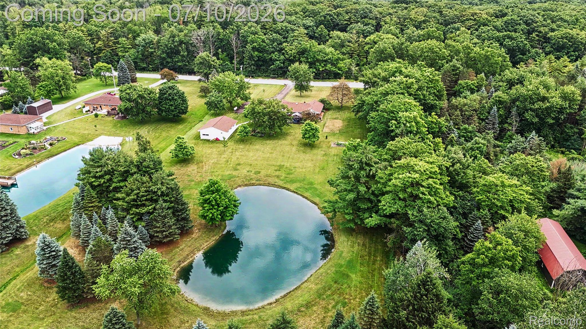 2180 Hurst Road St. Clair, MI 48079 - Photo 37 of 39 Expansive property featuring two distinct ponds, surrounded by mature trees and lush green landscaping