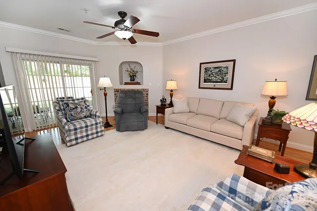 a view of empty room with fireplace and wooden floor
