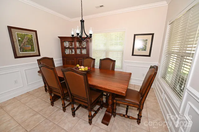 a view of a dining room with furniture and a window