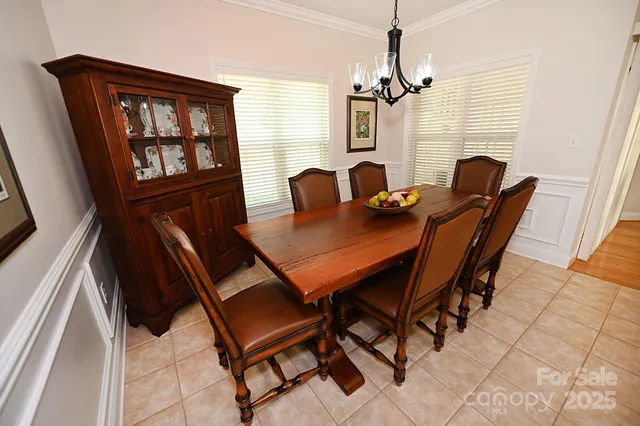 a living room with furniture and a dining table