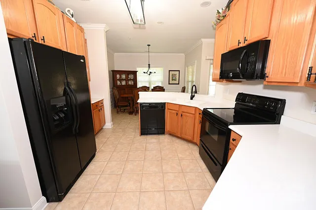 a kitchen with stainless steel appliances granite countertop a refrigerator and a stove top oven
