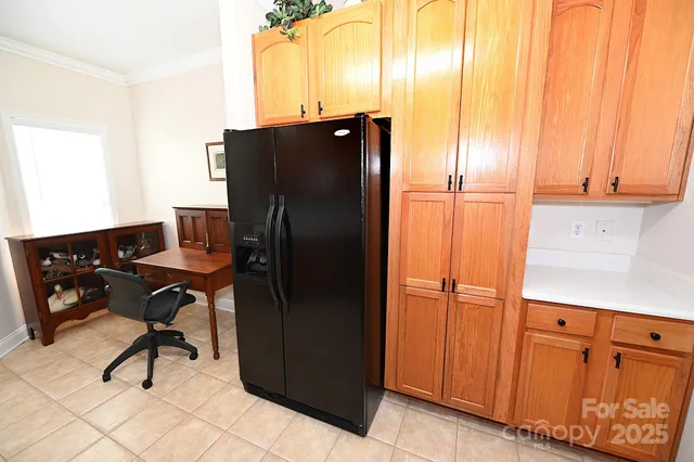 a kitchen with granite countertop a refrigerator a stove top oven a sink and dishwasher